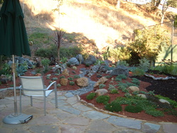 Slate rock patio and walkway as part of backyard landscape.